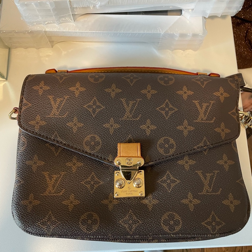 Brown crossbody bag with “LV” logo